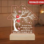 Personalized family tree lamp with engraved text on a wooden base.