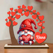 Gnome figurine holding a heart with 'Nana' on it, surrounded by red hearts and a tree-like structure.
