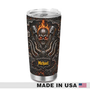 A stainless steel travel tumbler with a clear lid, featuring a custom graphic of a flaming skull over an engine design. The name 'Michael' is printed in yellow near the bottom.