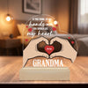 Decorative lamp with hands forming a heart and text on a wooden base.