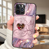 Phone case with 'In Loving Memory' design held by a person in a living room.