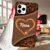 Phone case with 'Nana' design held by a hand in a living room.