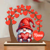 Gnome figurine holding a heart with 'Nana' on it, surrounded by red hearts and a tree-like structure.