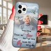Phone case with a portrait of an elderly woman and a quote, held by a person indoors.