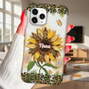 Phone case with sunflower design and 'Nana' text held by a hand in a living room.